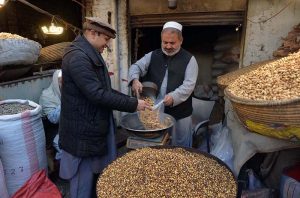 Vendor selling and displaying peanuts to attract the customers at Firdous area.