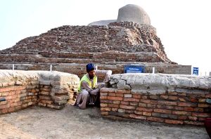 Labourers are busy repairing work of the walls in front of Stupa at world famous archeological site of Mohen jo-Daro (Mound of Dead).