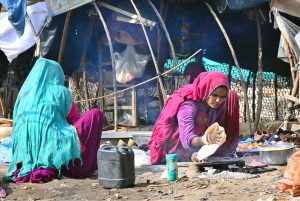 Children are enjoying playing with stone at dry area of Indus River