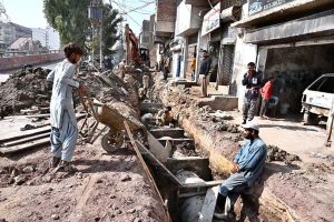 Labourers are busy preparing sewerage nullah at Autobahn Road during development work in the city