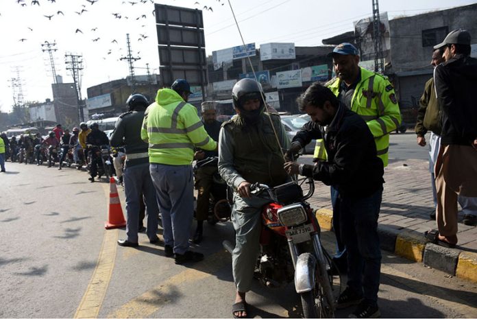 Traffic police begin installing free safety rods on motorcycles ahead of the Basant festival in the Provicial Capital