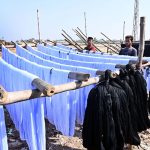 Workers busy dyeing yarn and laying it out to dry in the sun after processing at a factory in the Phulei area