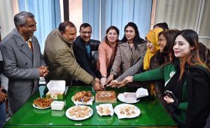 Managing Director Associated Press of Pakistan (APP) Muhammad Asim Khichi cutting a cake to celebrate the New Year celebration during a ceremony organized by staffers at APP Headquarters.