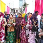 Brides and grooms enter a marriage hall during the 19th Combined Marriages Program, organized by the Pakistan Hindu Council at the Railway Ground.