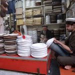 A craftsman stitches a traditional Chitrali cap at his workplace in Jahangir Pura Bazaar as demand for the cap rises during extreme cold weather in the city.