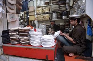 A craftsman stitches a traditional Chitrali cap at his workplace in Jahangir Pura Bazaar as demand for the cap rises during extreme cold weather in the city.