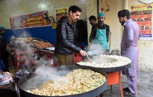 A vendor prepare to serves traditional food from his roadside setup at the busy streets offering a taste of local flavours in the provincial city .