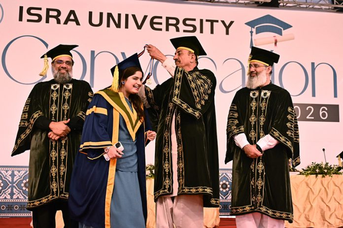 Sindh Minister for Universities & Boards Muhammad Ismail Rahoo awards a gold medal to a successful student during the 23rd convocation 2026 at Isra University