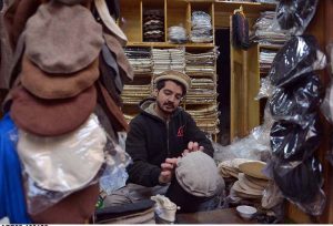A craftsman stitches a traditional Chitrali cap at his workplace in Jahangir Pura Bazaar as demand for the cap rises during extreme cold weather in the city.