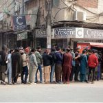 large number of people stand in a queue to receive free meals, highlighting ongoing relief efforts for the deserving in the city.