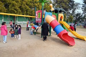 Children enjoying swings at Sukh Chayn Park in Federal Capital