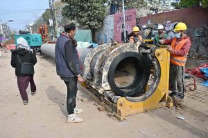 Workers are busy preparing pipes to be laid to turn wires underground on Saidpur Road