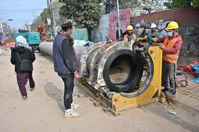 Workers are busy preparing pipes to be laid to turn wires underground on Saidpur Road