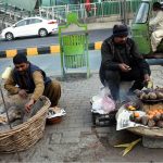 Street vendors display sweet potatoes to attract customers along Jail Road