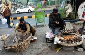 Street vendors display sweet potatoes to attract customers along Jail Road