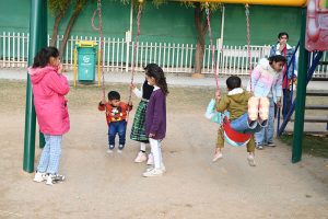 Children enjoying swings at Sukh Chayn Park in Federal Capital