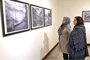 A visitor keenly viewing photography during a closing ceremony of photography exhibition and book launch titled "KASHMIR, WAIT & SEE" by Shah Zaman Baloch internationally renowned photographer Cédric Gerbehaye at PNCA.