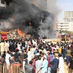 A view of Fire erupted last night at Gul Plaza shopping mall, and efforts to extinguish the massive blaze are still ongoing. Meanwhile, traders and their relatives are seen looking at the burnt mall