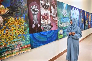 A visitor keenly viewing photography during a closing ceremony of photography exhibition and book launch titled "KASHMIR, WAIT & SEE" by Shah Zaman Baloch internationally renowned photographer Cédric Gerbehaye at PNCA.