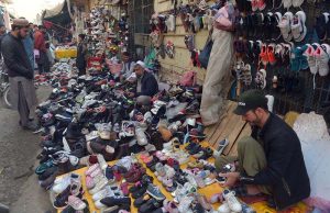 Vendors display second-hand imported shoes at Faqirabad to attract customers, offering affordable options in the local market.