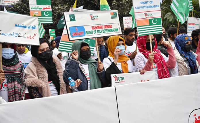 A large number of people participate in a walk expressing solidarity with Kashmiris on Right to Self-Determination Day in front of the Lahore Press Club