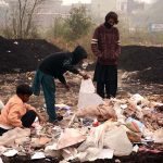 Gypsy youngsters search for valuables in a heap of garbage