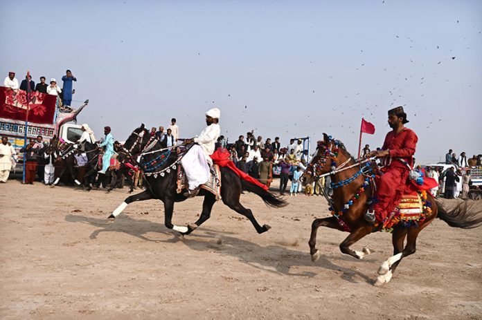 A view of horse racing during all Pakistan horse riding competition winter sports festival 2026 at bypass ground
