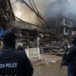 Special Security Unit (SSU) commandos are seen alert at the site of Gul Plaza, where a fire erupted last night