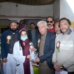 Federal Minister for Investment Board Qaiser Ahmad Sheikh giving shield to a doctor for best performance in medical camp at Moza Jhanb at Lahore Road