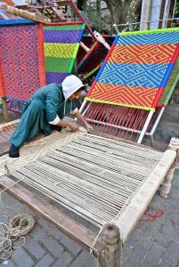 A craftsman busy in knitting a traditional bed (Charpai) at his workplace near Pakistan Chowk.