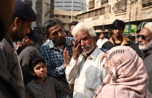 Special Security Unit (SSU) commandos are seen alert at the site of Gul Plaza, where a fire erupted last night
