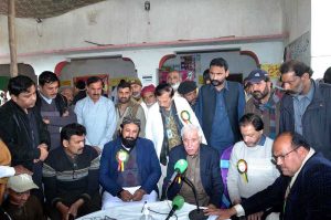 Federal Minister for Investment Board Qaiser Ahmad Sheikh giving shield to a doctor for best performance in medical camp at Moza Jhanb at Lahore Road