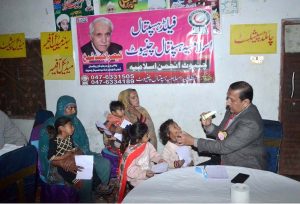 Federal Minister for Investment Board Qaiser Ahmad Sheikh giving shield to a doctor for best performance in medical camp at Moza Jhanb at Lahore Road