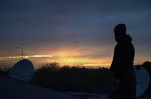 A silhouette of a passerby against a scenic sunset after rainfall in the Federal Capital.