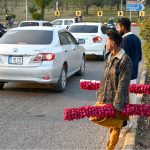 Young vendors selling floral bangles to attract customers at F-7 in the Federal Capital