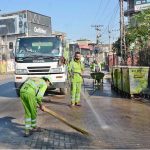 Faisalabad Waste Management Company (FWMC) workers wash a roadway with water as part of the ongoing Clean Punjab campaign in the city