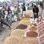 People purchase dry fruits at Jhang Moor