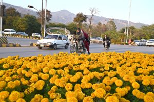 Young vendors selling floral bangles to attract customers at F-7 in the Federal Capital