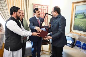 Chairman Senate Syed Yousaf Raza Gillani presents Souvenir to Mubashir Hassan Executive Director General /PIO in federal capital.