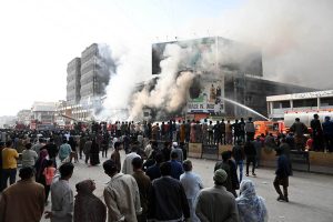 Special Security Unit (SSU) commandos are seen alert at the site of Gul Plaza, where a fire erupted last night