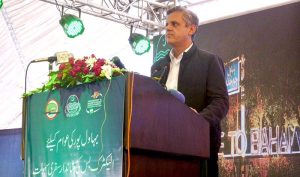 Provincial Minister for Transport Bilal Akbar speaks at the inauguration ceremony of the Green Electric Bus Service at Dring Stadium.
