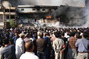 Special Security Unit (SSU) commandos are seen alert at the site of Gul Plaza, where a fire erupted last night