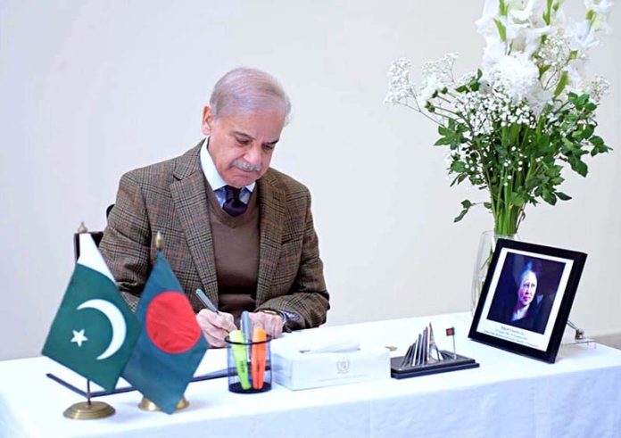 Prime Minister Muhammad Shehbaz Sharif writes down his remarks in the visitors' book as he visits Bangladesh High Commission to offer Condolences on the passing of Begum Khalida Zia former Prime Minister of Bangladesh and Chairperson of Bangladesh National Party