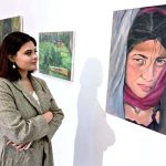 A visitor viewing the displayed art stuff during exhibition of Degree Show at NCA