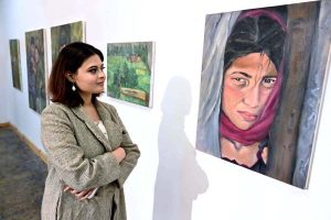 A visitor viewing the displayed art stuff during exhibition of Degree Show at NCA