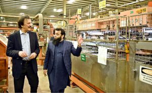 SAPM for Industries and Production Haroon Akhtar Khan inspecting a process of automotive glass manufacturing at the auto-glass processing unit during his visit of SME cluster at Bin Qasim.