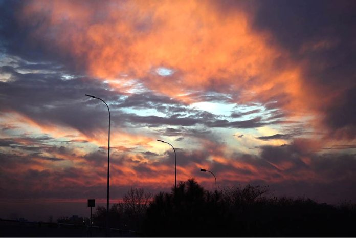 A fiery display of orange and red clouds lit up the sky during a recent sunset, casting striking silhouettes over the urban landscape of the Federal Capital