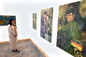 A visitor viewing the displayed art stuff during exhibition of Degree Show at NCA