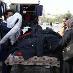 Customers busy selects and purchase used warm clothes from vendor during chilly weather in the metropolis