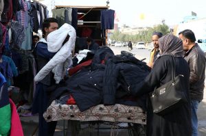 Customers busy selects and purchase used warm clothes from vendor during chilly weather in the metropolis
